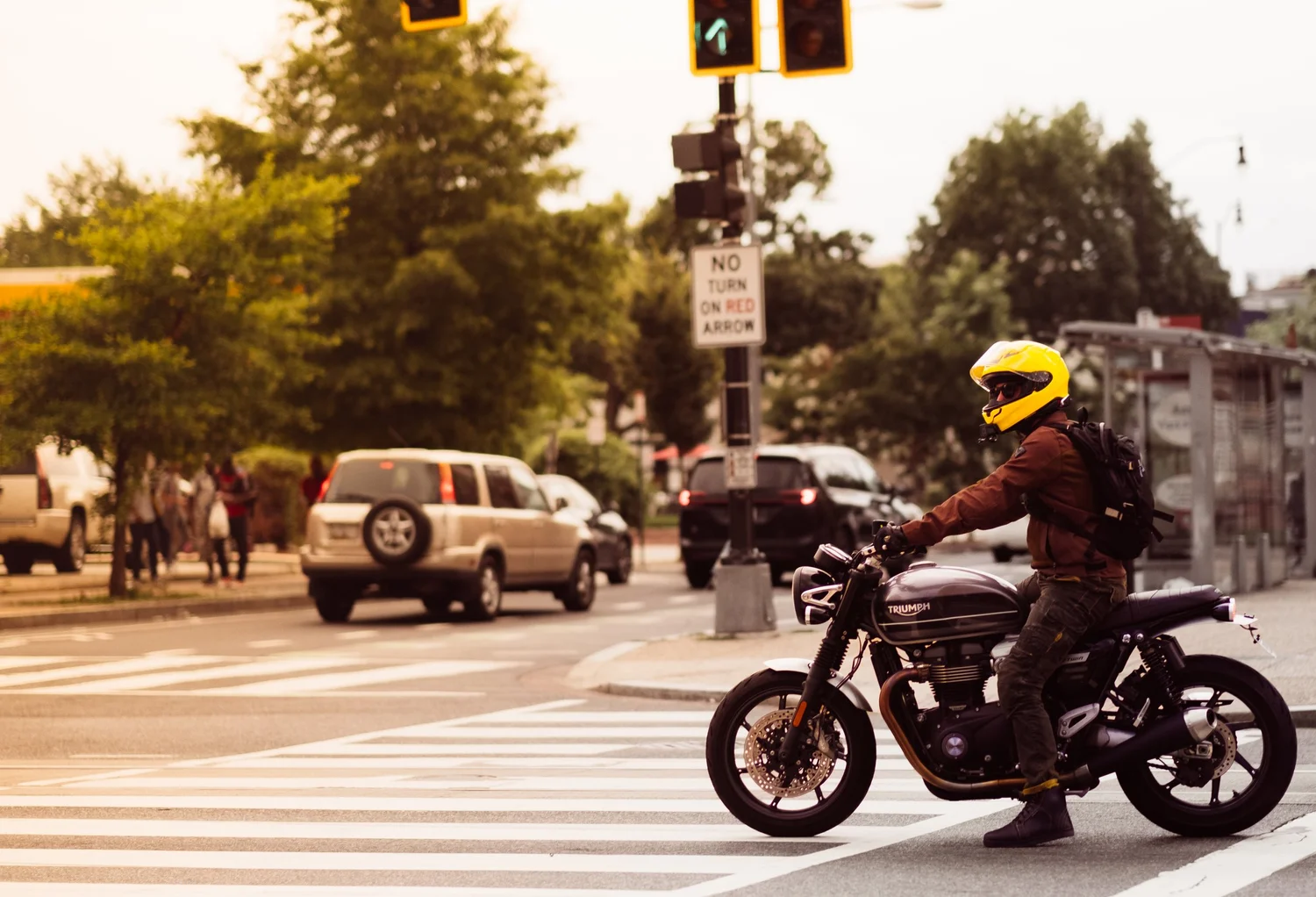 Street photograph — motorcyclist at a crosswalk